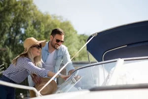 A couple inspect a boat they are thinking of buying