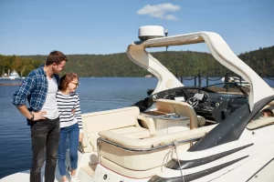 Couple standing on their new yacht on a sunny day