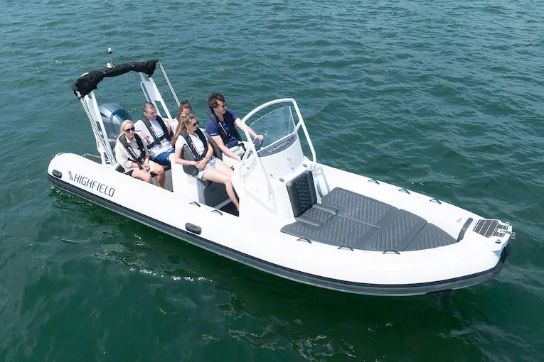 Highfield Sport 660 RIB boat with 5 people on the water, ideal for coastal trips.