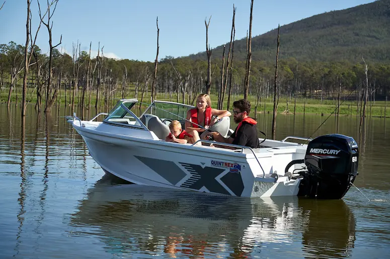 Quintrex boat with family enjoying a lake trip, perfect for budget boat buyers.