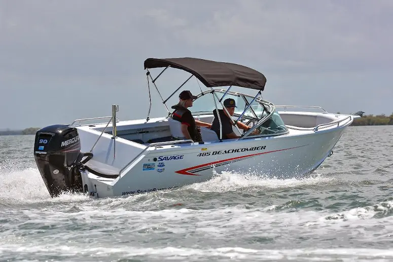 Savage 485 Beachcomber boat with two people on the water, ideal for budget boating