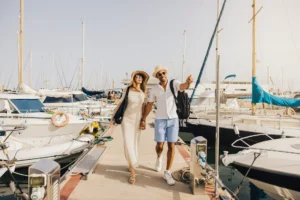Family cruising in a modern powerboat through a scenic bay with forested mountains at sunset.