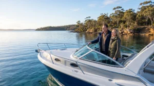 A lifestyle image of a couple enjoying the calm waters and early morning golden light on their boat, highlighting the benefits of boating in winter and smart off-season purchasing.
