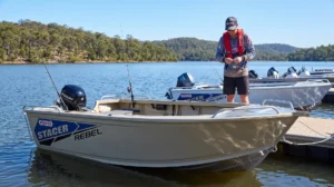 BRIG Eagle 6 RIB boat on water with two people, mountains in background.